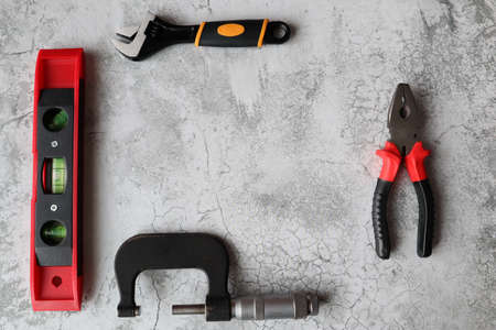 A set of tools on a gray background. top view. Space for text.の写真素材