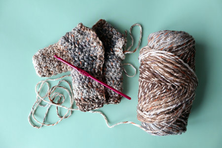 Knitting a cardigan for a doll made of brown yarn. Crocheting. DIY. top viewの写真素材