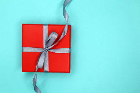 Red and gray theme gift box. Present gift with a bright red box. blue background. Concept of Valentines day. top view. flat lay.の写真素材