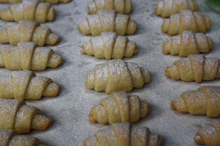Freshly baked bagels sprinkled with powdered sugar on a baking sheet. Summerの写真素材