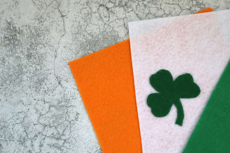 Green clovers from felt. Shamrocks on flag of Ireland background for St. Patrick's Day Holidayの写真素材