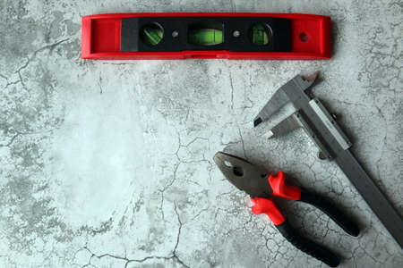A set of tools on a gray background. top view. Space for text.