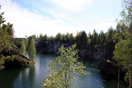 The amazing nature of the Karelian Isthmus. Forests of Karelia. View from a steep cliff to the green water of the lakeの写真素材
