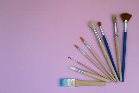 Brushes on a pink background with space to copy. Layout, mockup space for text, drawing. top viewの写真素材