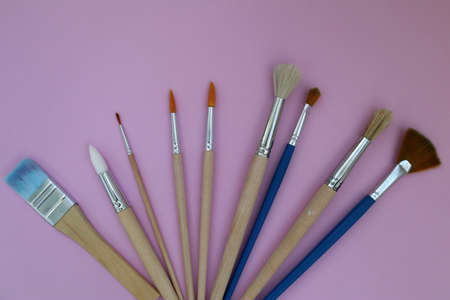 Brushes on a pink background with space to copy. Layout, mockup space for text, drawing. top viewの写真素材