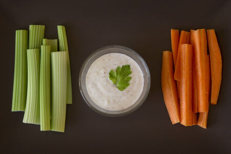 Pieces of carrot, celery and  sauceの写真素材