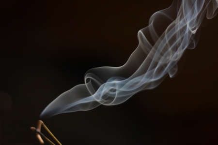 The smoke from the incense sticksの写真素材