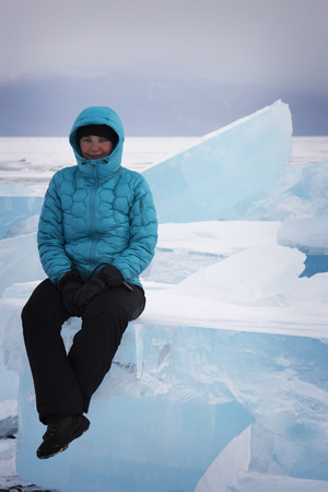 Girl sitting on the ice. Lake Baikal, Russia.の写真素材