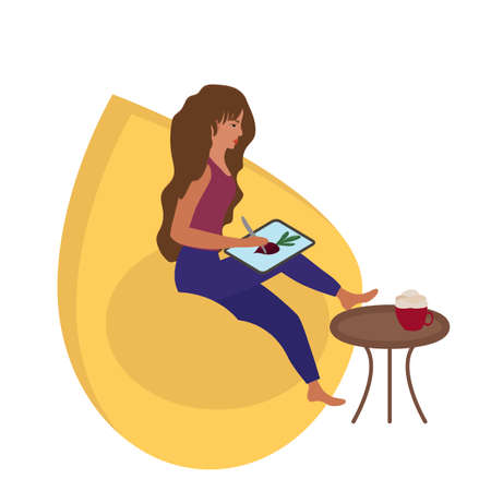 A girl draws an illustration on a tablet. Work from home online, freelance. A comfortable chair and a cup of coffee.のイラスト素材
