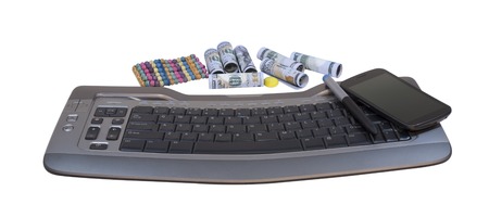 Money near to the keyboard and phoneの写真素材
