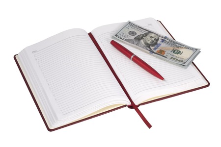Open notebook and money on a white backgroundの写真素材