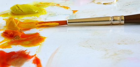 paints and brushes to paint on a light backgroundの写真素材