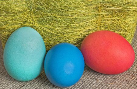 Multi-coloured Easter eggs on desktopの写真素材