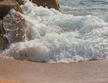 sea wave on the rocks in the summerの写真素材