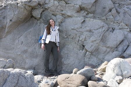 girl on the background of large stones on a haltの写真素材