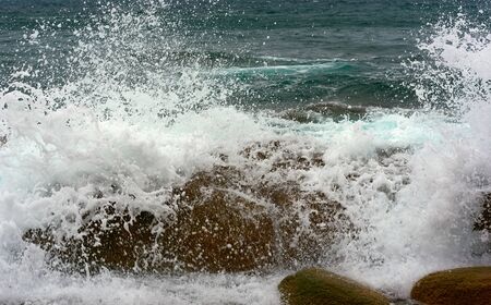the waves of the Pacific Ocean on the rocksの写真素材