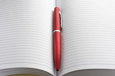 Open blank notebook and red pen closeupの写真素材