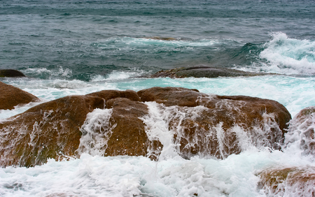 the waves of the Pacific Ocean on the rocksの写真素材