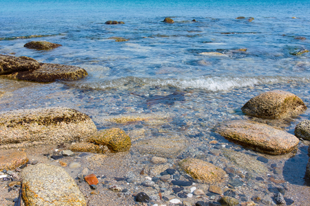 Sand and rocks on the shore of the Pacific Ocean in the summerの写真素材