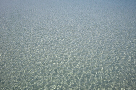 smooth surface of the sea on a sunny dayの写真素材