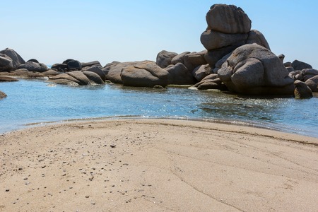 Sand and rocks on the shore of the Pacific Ocean in the summerの写真素材