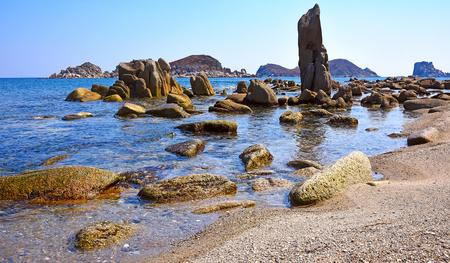 Sand and rocks on the shore of the Pacific Ocean in the summerの写真素材
