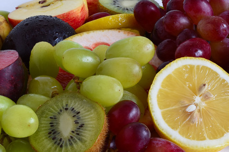 Grape, apple, kiwi and other fruits closeup. Fruit slicesの写真素材