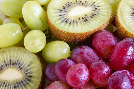 Grape, apple, kiwi and other fruits closeup. Fruit slicesの写真素材