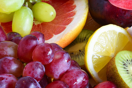 Grape, apple, kiwi and other fruits closeup. Fruit slicesの写真素材