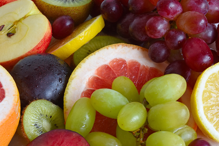 Grape, apple, kiwi and other fruits closeup. Fruit slicesの写真素材