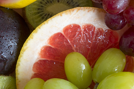 Grape, apple, kiwi and other fruits closeup. Fruit slicesの写真素材