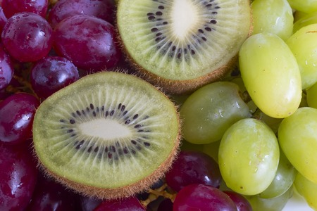 Grape, apple, kiwi and other fruits closeup. Fruit slicesの写真素材