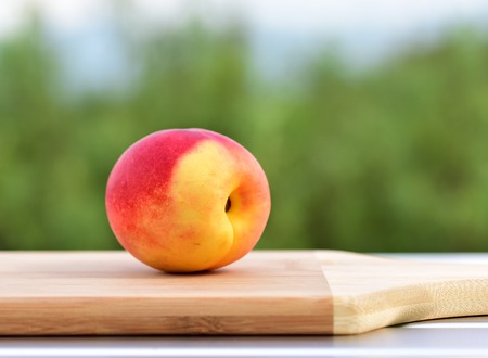 Peach on the table. Ripe peach on a green backgroundの写真素材