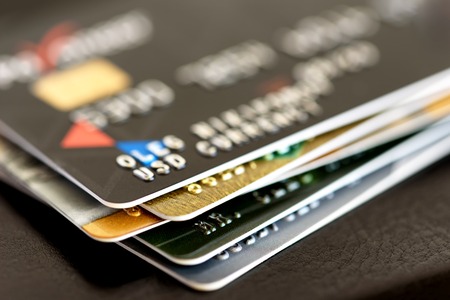 Credit card close-up. Plastic card on black backgroundの写真素材