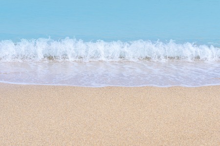 Wave of blue sea on sandy beach. Sea surface background.の写真素材