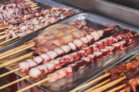 Street food asia. Squid on a stick.の写真素材