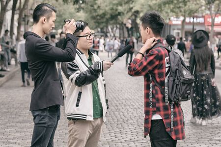 Harbin, Heilongjiang, China - September 2018: Filming interview. Blogger writes video reportのeditorial素材