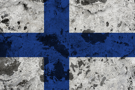Finland flag on old wall. Patriotic grunge background. National flag of Finlandの写真素材
