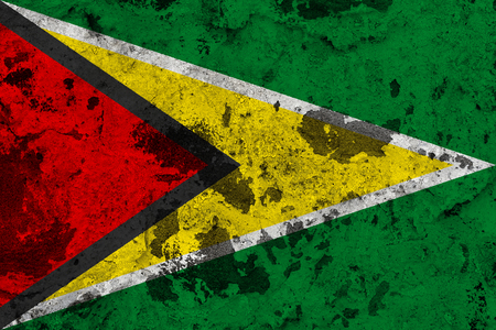 Guyana flag on old wall. Patriotic grunge background. National flag of Guyana