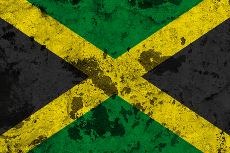 Jamaica flag on old wall. Patriotic grunge background. National flag of Jamaicaの写真素材