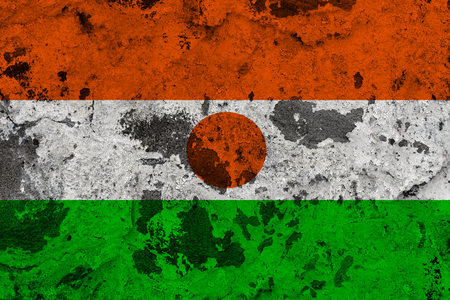 Niger flag on old wall. Patriotic grunge background. National flag of Nigerの写真素材