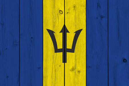 Barbados flag painted on old wood plank. Patriotic background. National flag of Barbadosの写真素材
