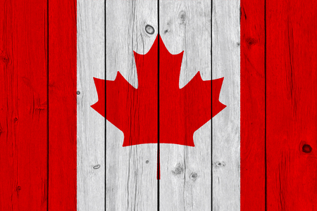 Canada flag painted on old wood plank. Patriotic background. National flag of Canadaの写真素材