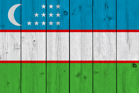 Uzbekistan flag painted on old wood plank. Patriotic background. National flag of Uzbekistanの写真素材