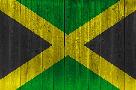 Jamaica flag painted on old wood plank. Patriotic background. National flag of Jamaicaの写真素材