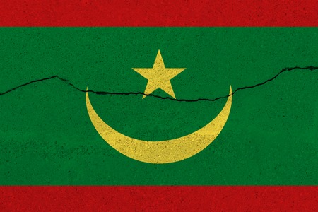 Mauritania flag on concrete wall with crack. Patriotic grunge background. National flag of Mauritaniaの写真素材