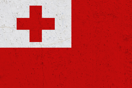Tonga flag on concrete wall. Patriotic grunge background. National flag of Tongaの写真素材