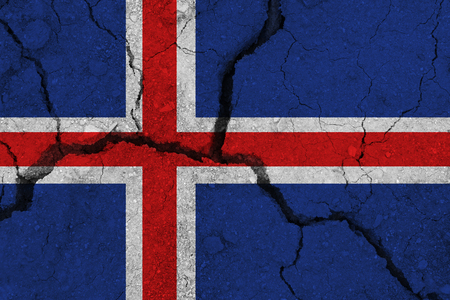 Iceland flag on the cracked earth. National flag of Iceland. Earthquake or drought conceptの写真素材