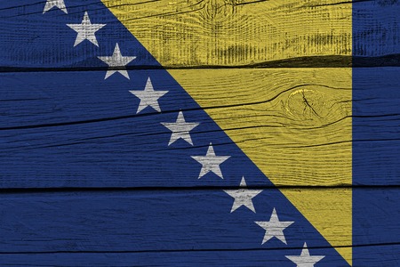 Bosnia and Herzegovina flag painted on old wood plank. Patriotic background. National flag of Bosnia and Herzegovinaの写真素材
