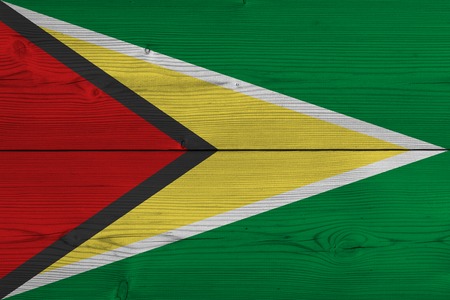 Guyana flag painted on old wood plank. Patriotic background. National flag of Guyanaの写真素材